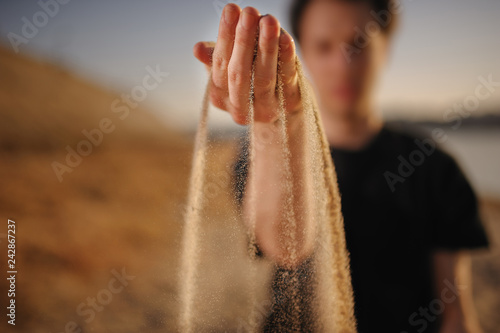 Wallpaper Mural Hand with sand sipping through. Shallow depth of field. Torontodigital.ca