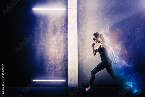 Fototapeta Naklejka Na Ścianę i Meble -  Sporty girl running next to the grungy textured wall with neon lights. Endurance and energy concept.