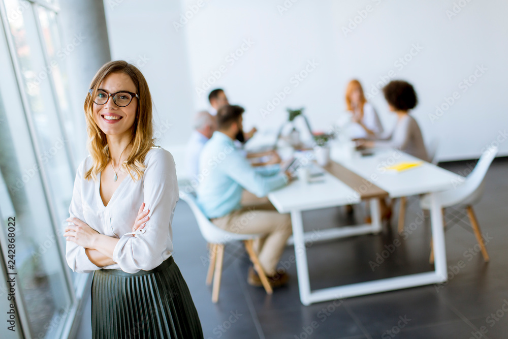 Elegant businesswoman standing in office Elegant businesswoman standing in office
