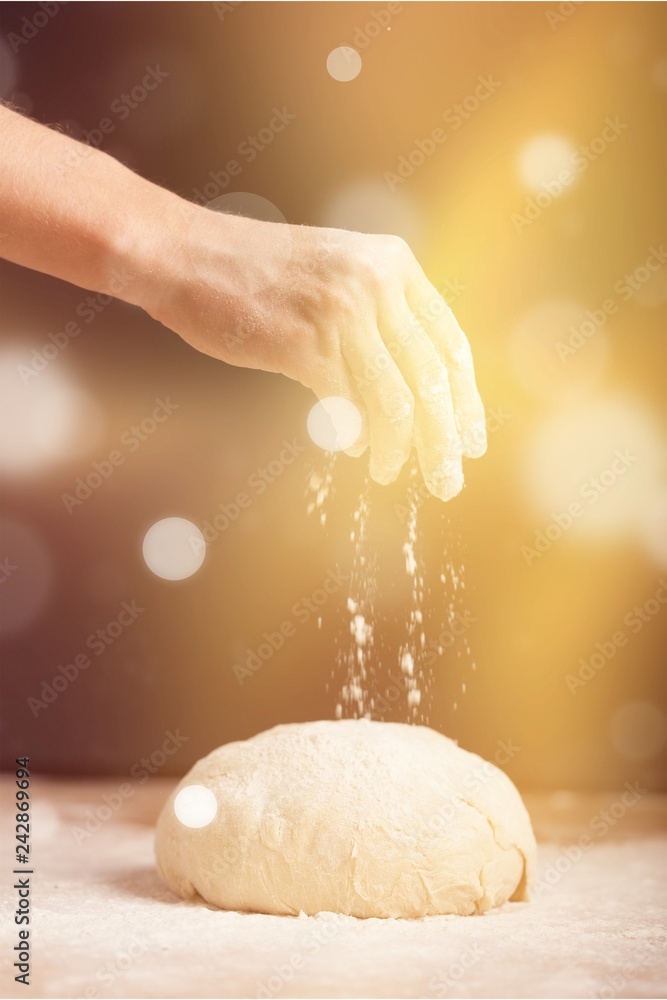 Fototapeta premium Woman's hands knead the dough close up