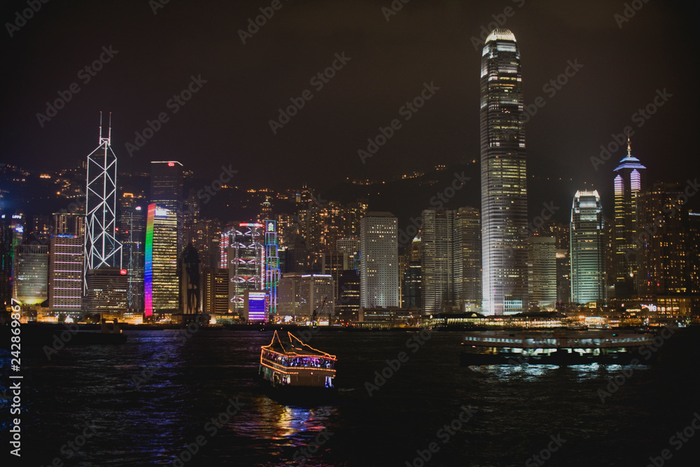 custom made wallpaper toronto digitalBoat in the harbor in front of illuminated buildings in an urban city at night.