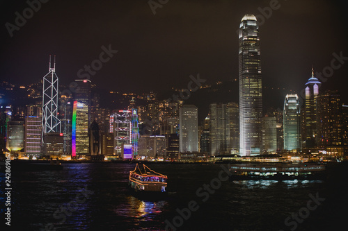 Wallpaper Mural Boat in the harbor in front of illuminated buildings in an urban city at night. Torontodigital.ca