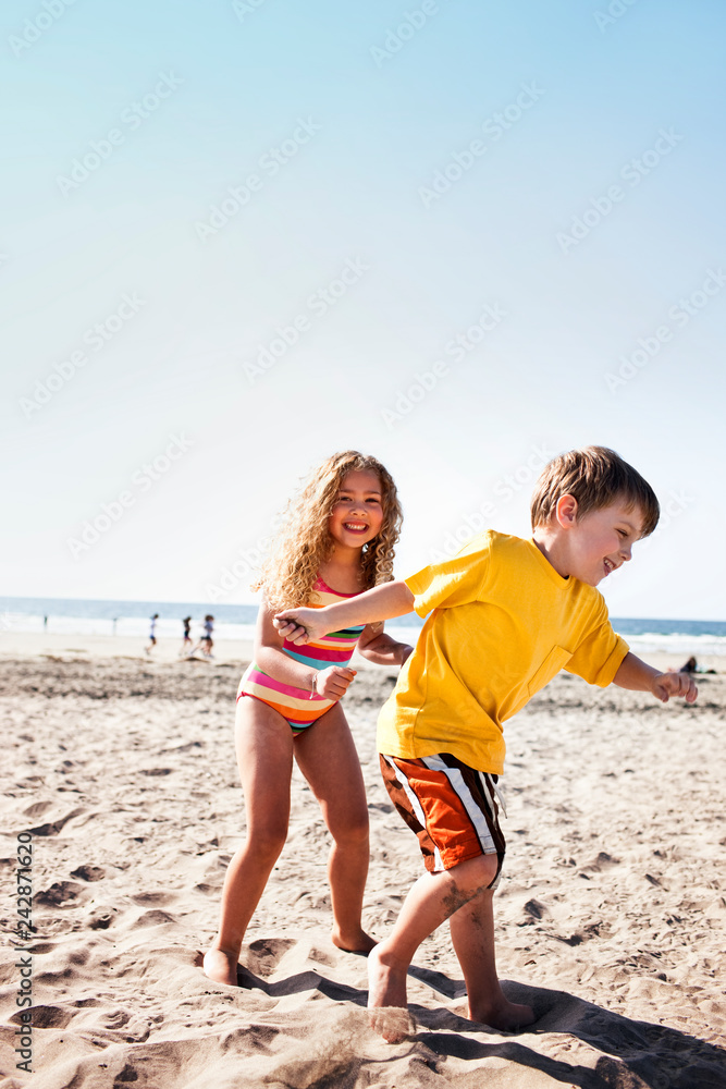 Brother and sister playing at the beach. Brother and sister playing at the beach.