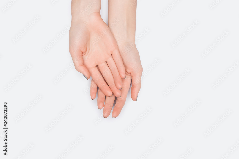 top view of female hands isolated on white