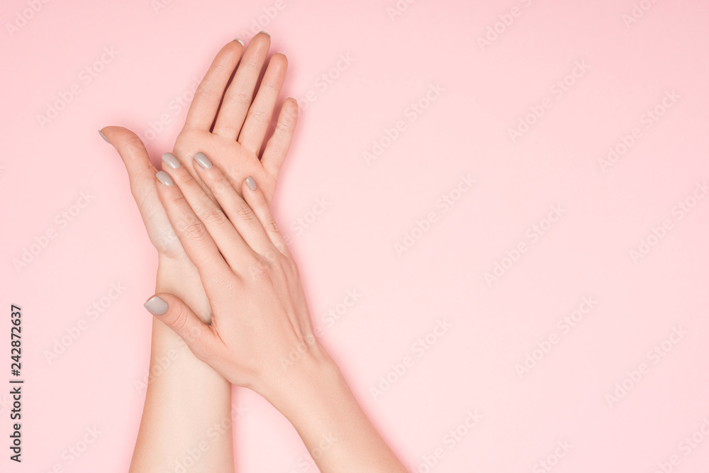 cropped view of female hands isolated on pink with copy space cropped view of female hands isolated on pink with copy space