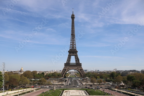 Eiffel Tower and there are a lot of tourists, cars and trees near it © kazanovskyiphoto