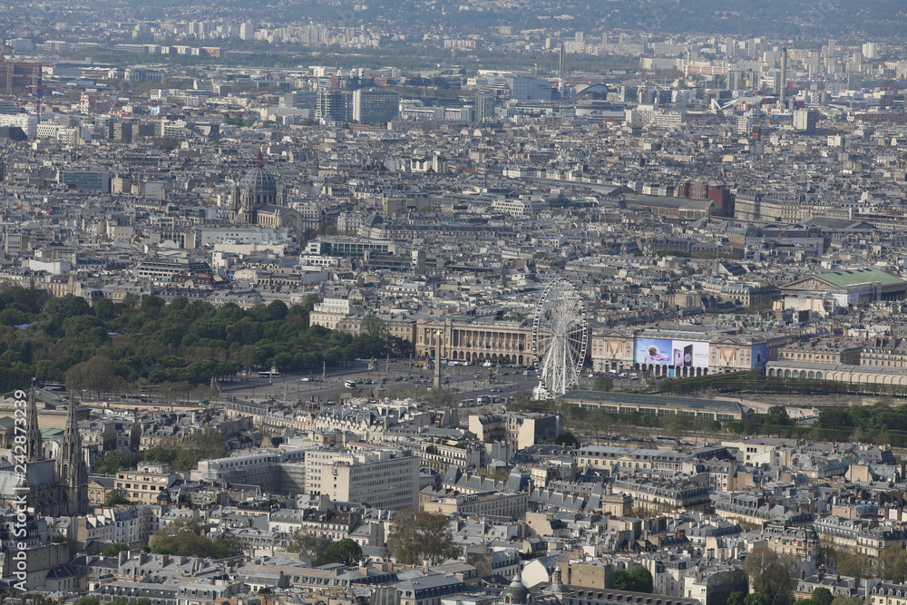 Top view of different houses and buildings as well as the Ferris wheel in Paris