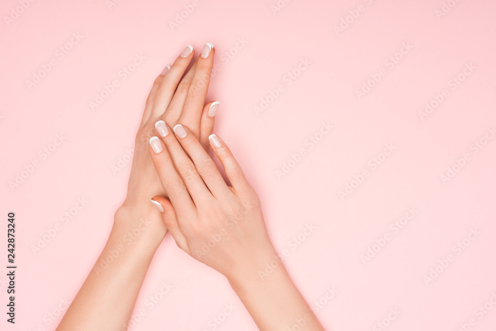 partial view of female hands isolated on pink with copy space partial view of female hands isolated on pink with copy space