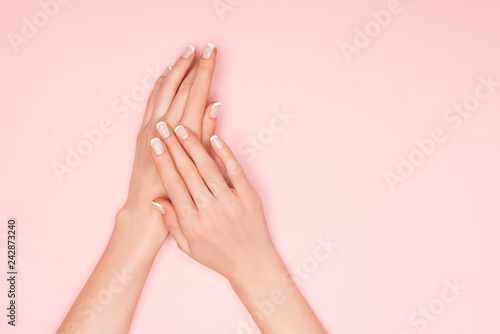 partial view of female hands isolated on pink with copy space