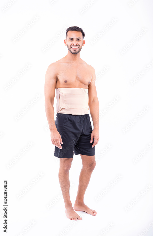 shirtless man in studio with white background wearing orthopedic corset shirtless man in studio with white background wearing orthopedic corset