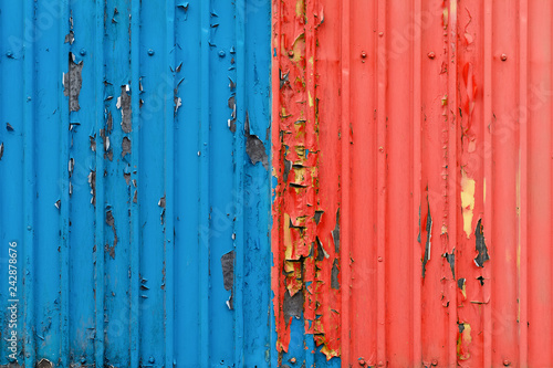 two-tone background.peeling paint on a shipping container.