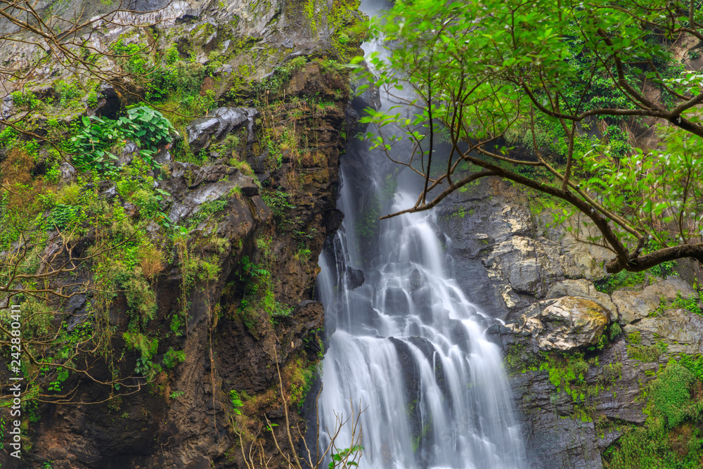 Obraz premium Khlong Lan Waterfall, the beautiful waterfall in deep forest at Khlong Lan National Park ,Kamphaeng Phet, Thailand,