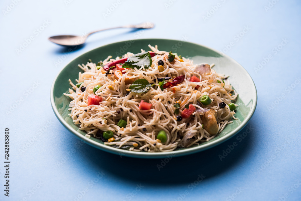 Spicy semiya uppma or upma served in plate. selective focus Spicy semiya uppma or upma served in plate. selective focus