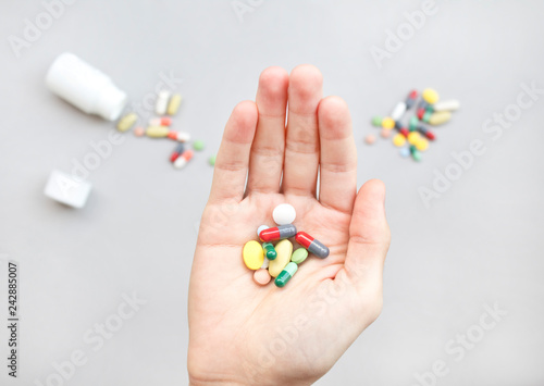 Colorful pills and medicines in the hand