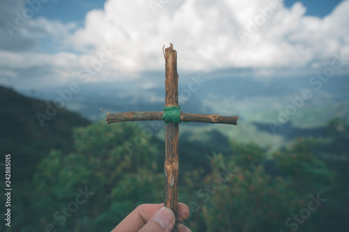 The cross with nature in the forest on the hill is the Blackground.