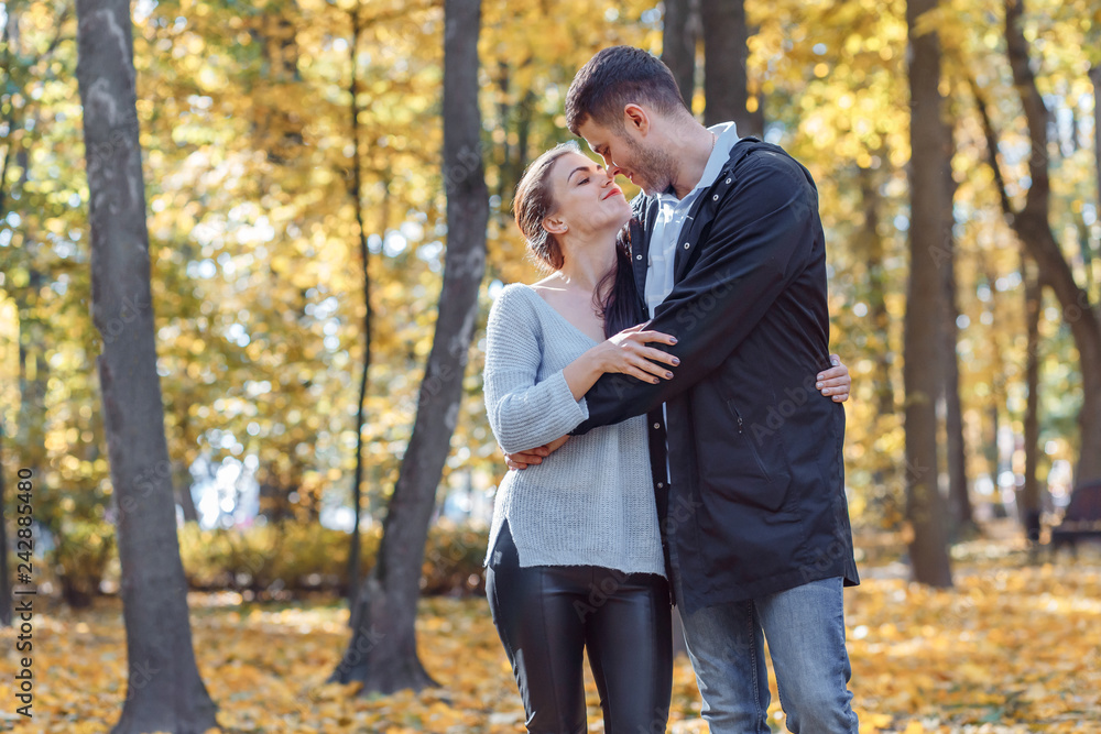 Natural photos of a happy couple in love having fun outside on a sunny autumn day. Togetherness and happiness concept Natural photos of a happy couple in love having fun outside on a sunny autumn day. Togetherness and happiness concept