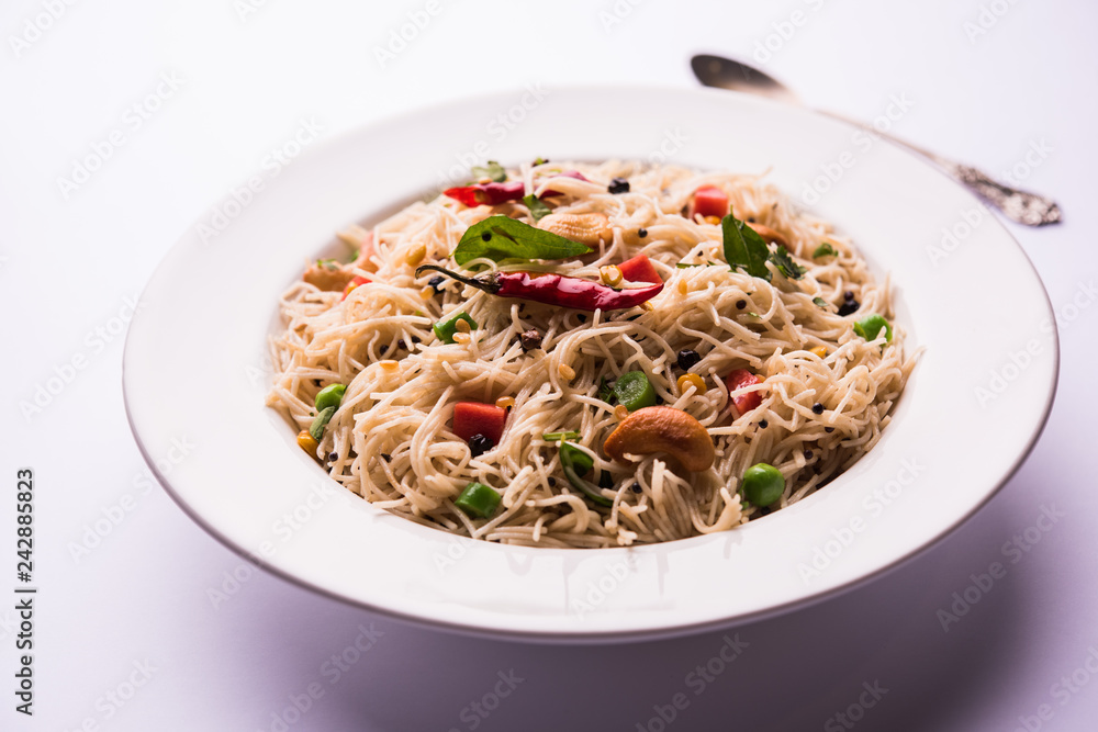 Semiya Upma or Vermicelli Uppuma or uppittu is a popular breakfast menu from south India. served in a bowl. selective focus