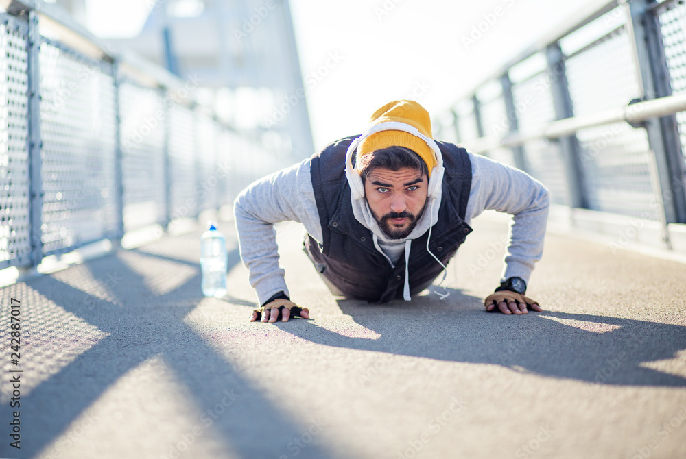 Sportsman doing push-ups at bridge Sportsman doing push-ups at bridge