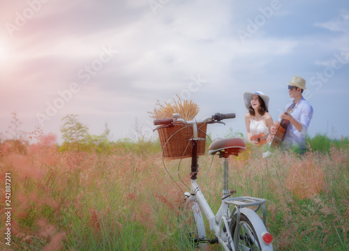 retro bycycle standing in the meadow flowers waiting couple lover, softening sweet and ramantic playing song singing together in valentine honeymoon occasion photo