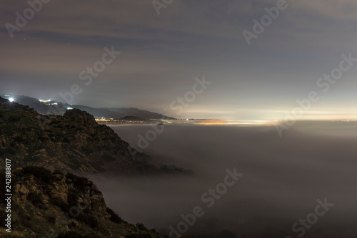 Foggy dawn view towards Porter Ranch in the west San Fernando Valley area of Los Angeles in Southern California. Shot taken from hilltop in Santa Susana Mountains. 