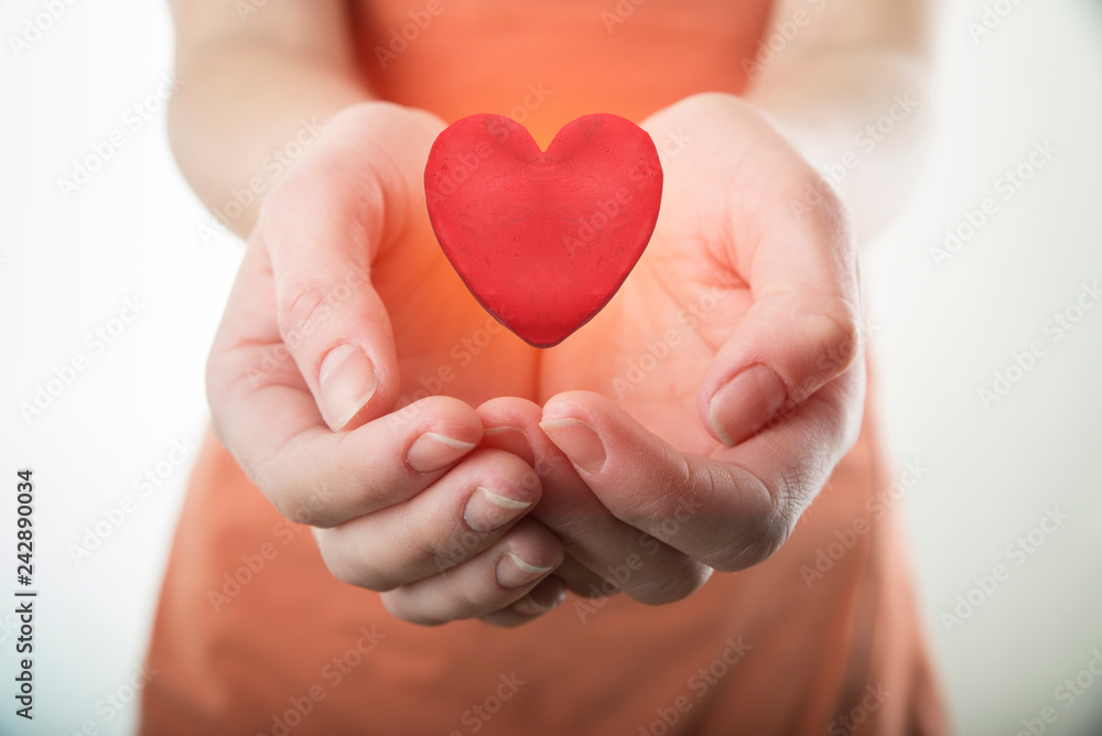 Man holding paper heart on wooden background, top view with space for text Man holding paper heart on wooden background, top view with space for text