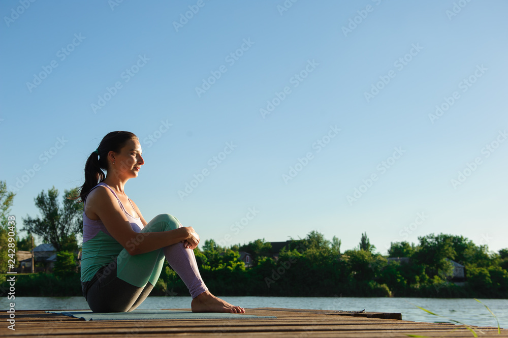 Young girl doing yoga fitness exercise outdoor in beautiful landscape. Morning sunrise. Meditation and Relax.