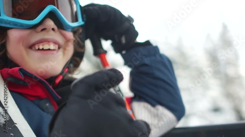 Close portrait of a teenager boy in a helmet and goggles in a ski lift cabin. Ski resort, Happy family vacation in the mountains
