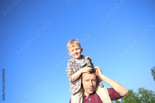 boy shoulders father spring sunny sky