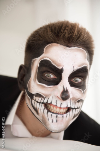 Man with make-up Halloween. Drawing a vampire, skeleton