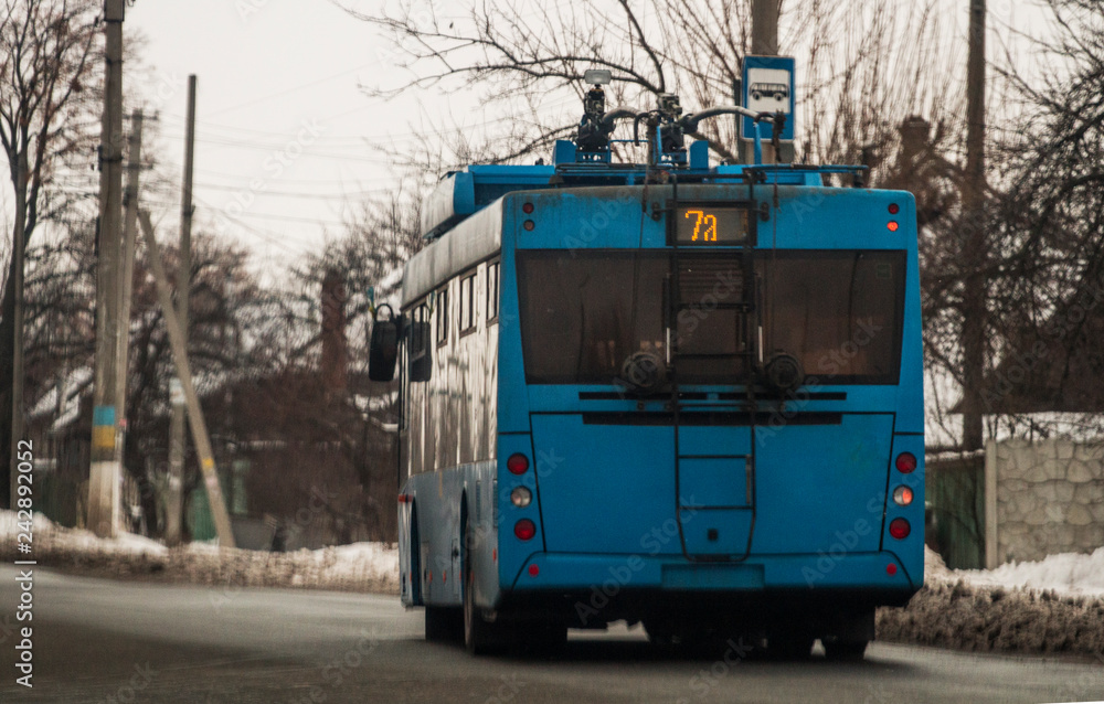Trolleybus driving down the road.