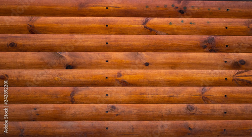 Brown wood texture. Wall of the wooden house.