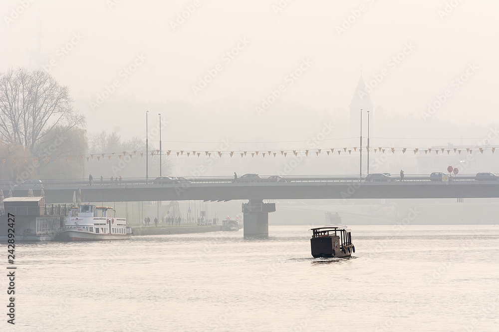 Bridge in Krakow in foggy day (Poland)