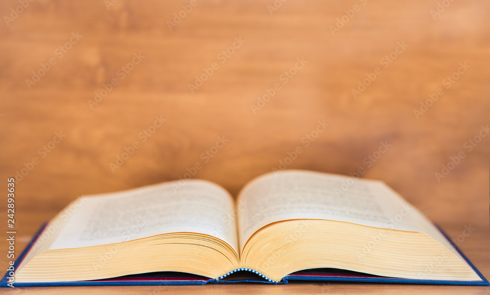 Obraz premium Open book on wooden background.