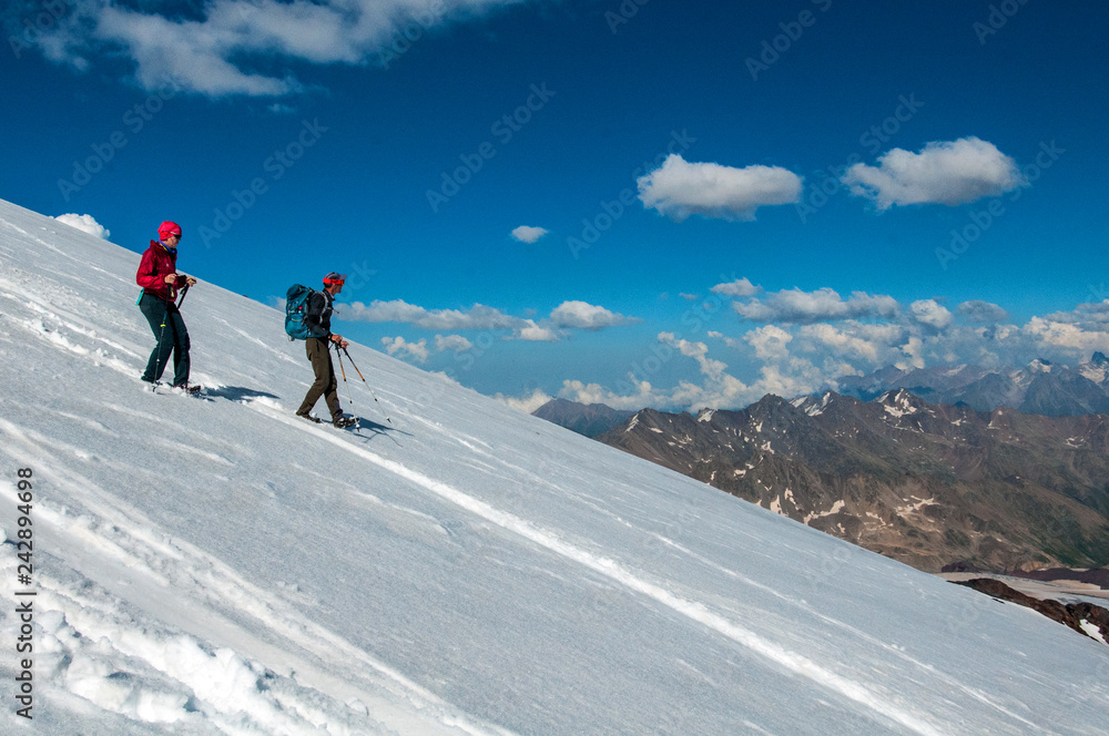 tourists in the snowy Caucasus mountains in July