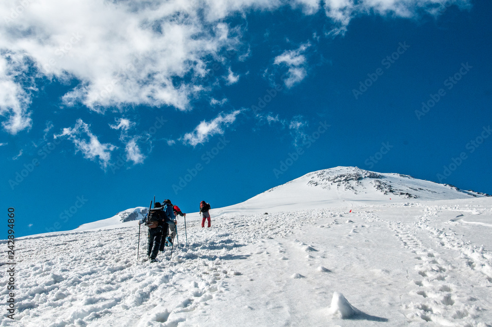 tourists in the snowy Caucasus mountains in July