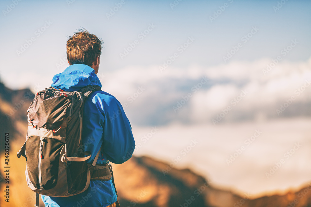 Hiker travel lifestyle young man wearing jacket and backpack on trek trip  outdoor in mountains. Stock Photo | Adobe Stock
