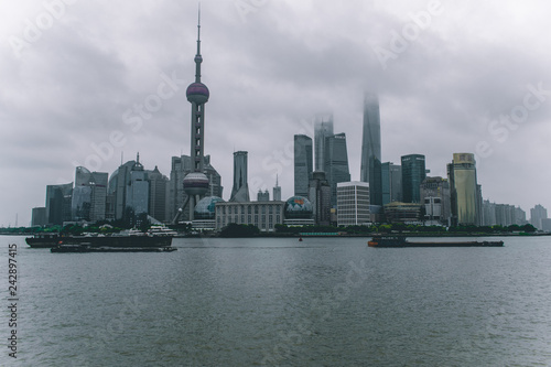  Shanghai / China - may 22 2017: Shanghai skyline on a cloudy day with the skyscrapers covered in louds and mist 