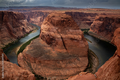 The river bends through the canyon in the desert