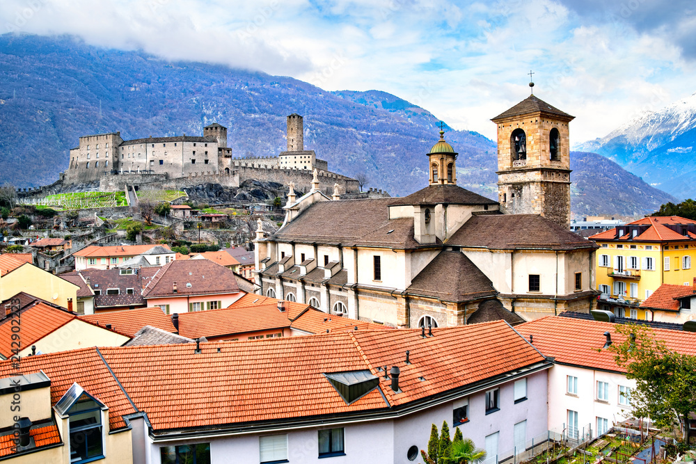 Beautiful ancient city of Bellinzona in Switzerland with Collegiata dei Ss. Pietro e Stefano church and Castelgrande castle on background