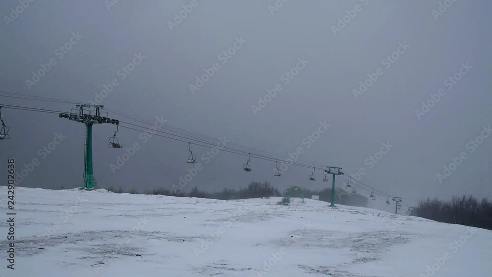 Dramatic sky in the snow-capped mountains, Dramatic clouds blowing breeze over an mountains, ski lift in the mountains, ski lift in the bad weather Dramatic sky in the snow-capped mountains, Dramatic clouds blowing breeze over an mountains, ski lift in the mountains, ski lift in the bad weather