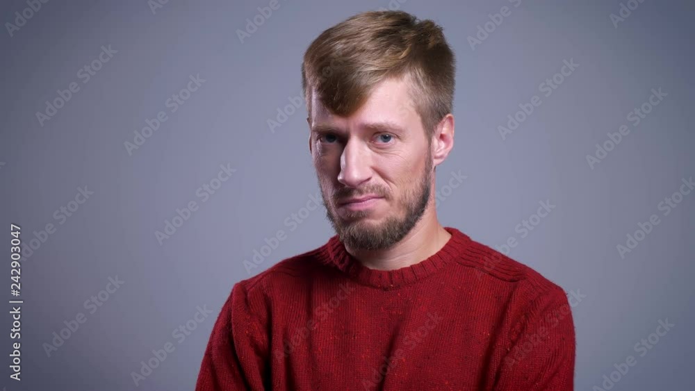 Closeup portrait of skeptical middle-aged caucasian man looking straight at camera Closeup portrait of skeptical middle-aged caucasian man looking straight at camera