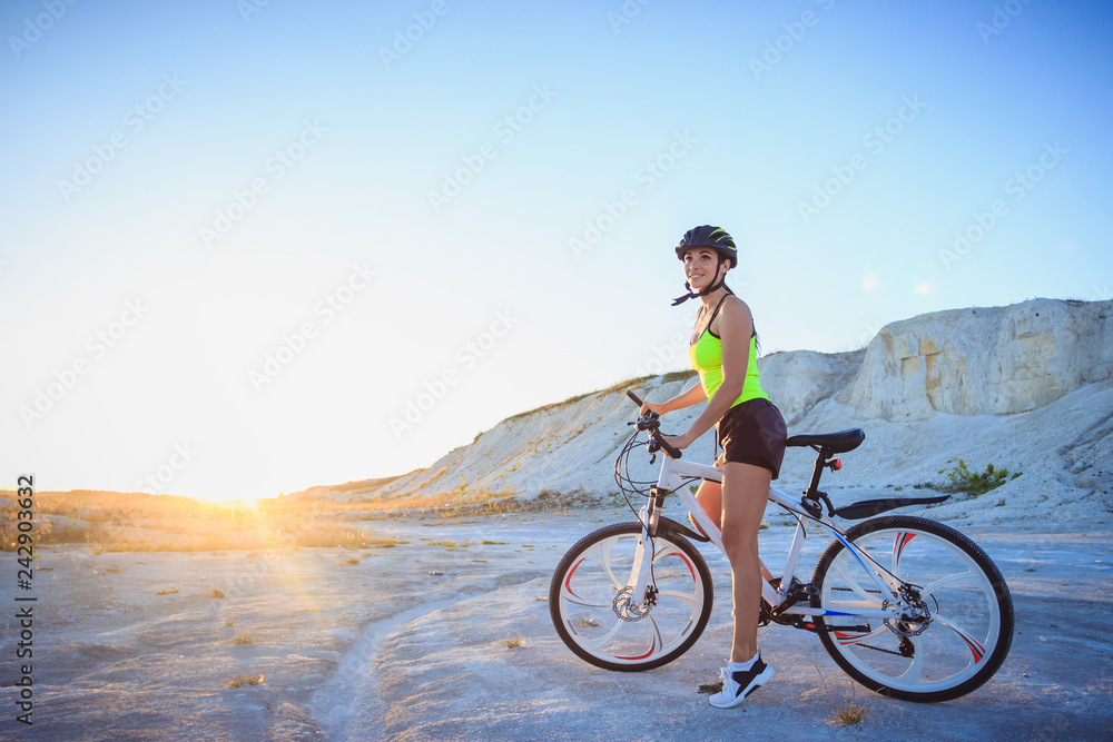 Fototapeta premium Young beautiful woman with a sport bike, soft focus background