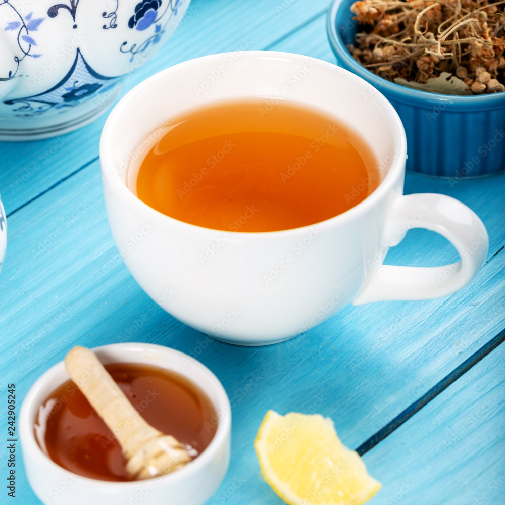 Cup of Linden Tea, Dried Linden Flowers in Cup with honey and lemon on wooden background. Cup of Linden Tea, Dried Linden Flowers in Cup with honey and lemon on wooden background.