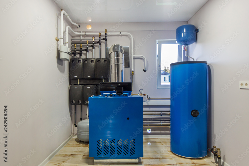 Gas Boiler room in a private house. Heating system with hot water thermal storage tank Gas Boiler room in a private house. Heating system with hot water thermal storage tank