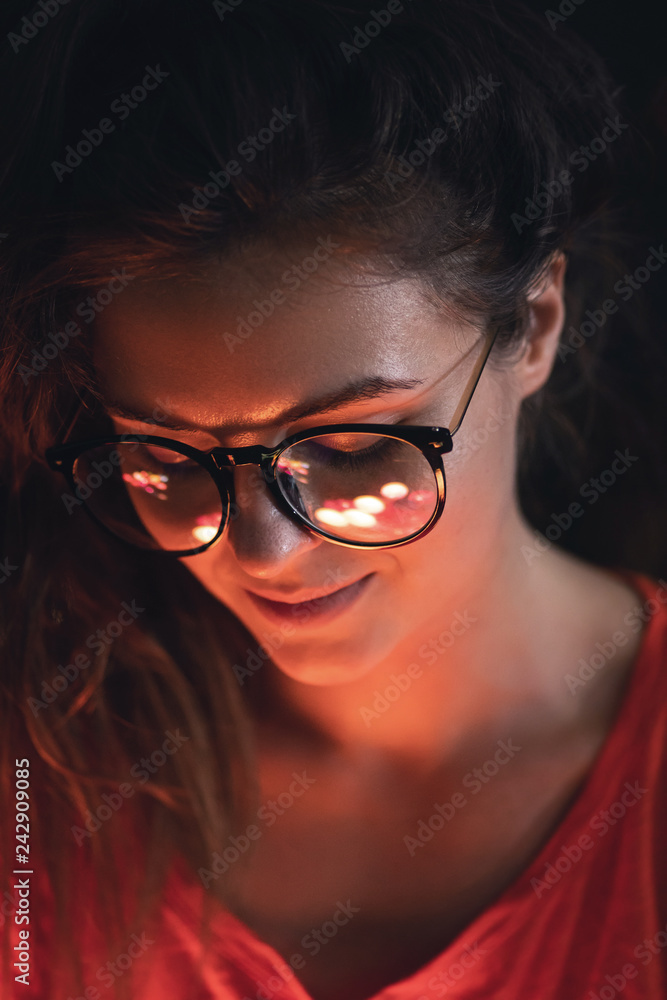Young woman with reflection of glowing light balls in her eye glasses Young woman with reflection of glowing light balls in her eye glasses