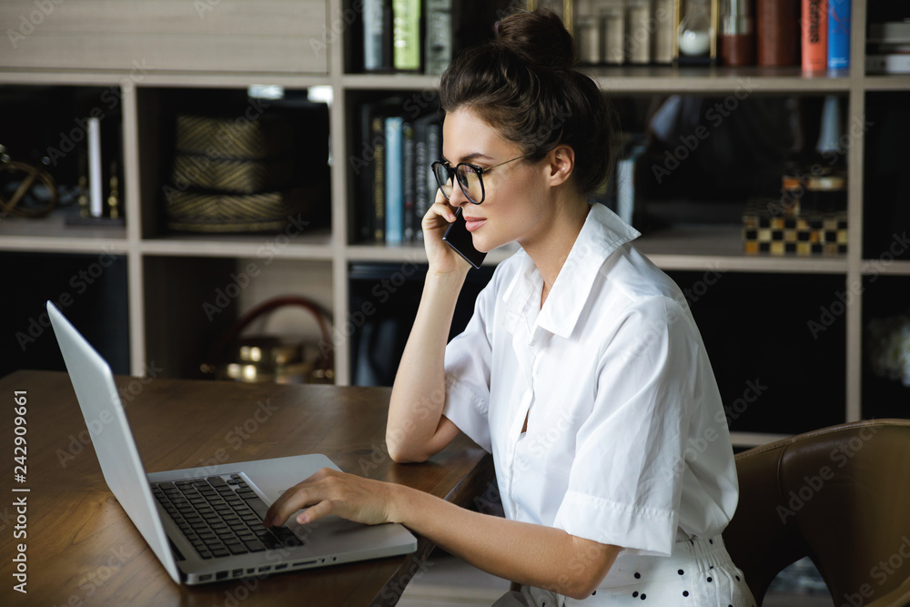 Young businesswoman is talking by smartphone Young businesswoman is talking by smartphone