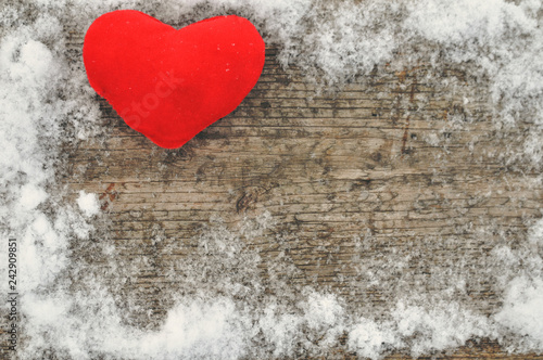 Valentine s day and Love composition with red plush heart on wooden background in snow. Healthy lifestyle concept.
