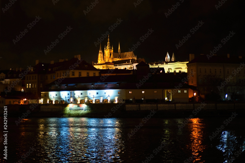 Prague castle and river at night.