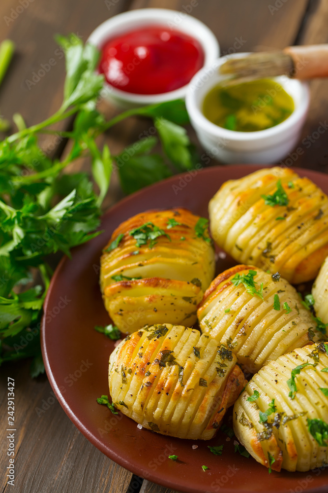 Hasselback potatoes on wooden surface