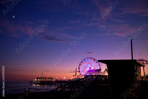 pier at sunset with farris wheel